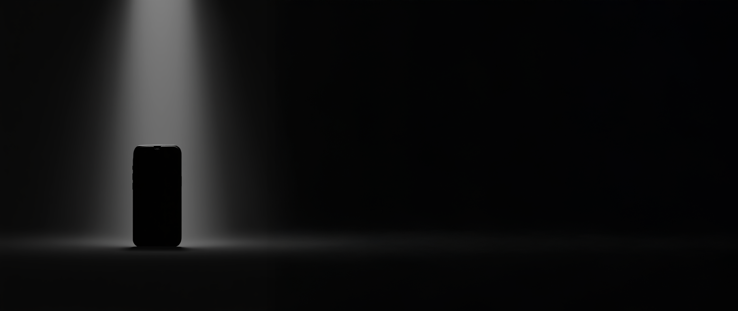 Hero Section_Dark moody image, spotlight on mobile phone